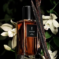 YSL LVDP Babycat Eau de Parfum, a luxurious fragrance bottle amidst vanilla pods and delicate white orchids.