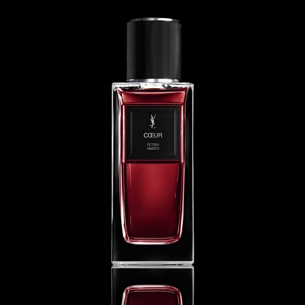 COEUR Eau de Parfum ruby-red bottle with black cap on a reflective YSL background.