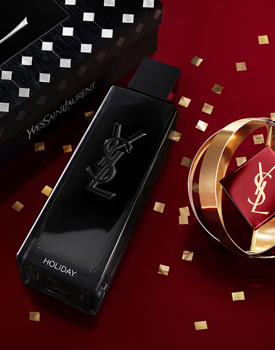 Custom engraved MYSLF fragrance bottle showcased on a festive red surface with gold details.
