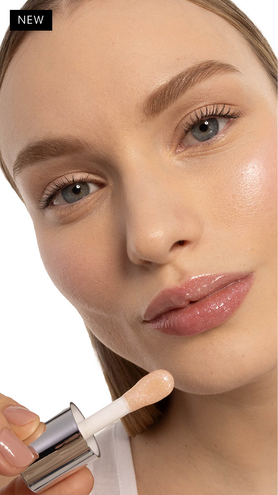 Mira, fair-skinned, with YSL LOVESHINE Plumping Lip Oil Gloss in Shade 10 Stardust Love, showcasing glossy lips.