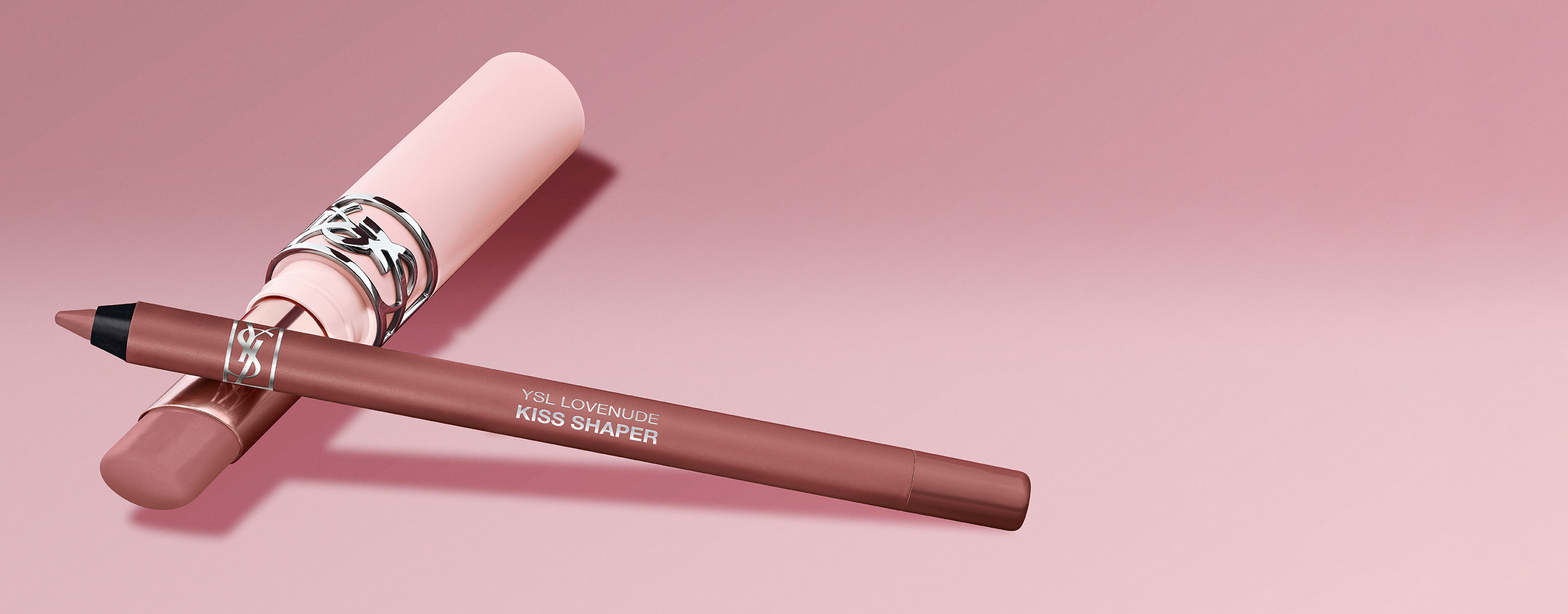 YSL LOVENUDE Kiss Shaper and Lip Blusher in Shade 1, digital still life on a soft pink background.