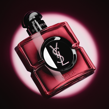 Close-up of the pink lacquered Black Opium Eau de Parfum Pink Glaze bottle with a heart and YSL engraving at the base.