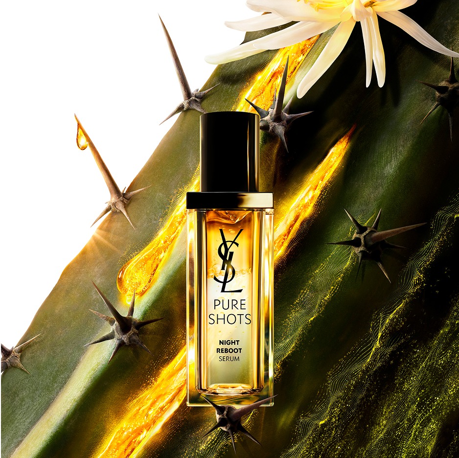YSL Pure Shots Night Reboot Serum bottle, set against a Moonlight Cactus with a white flower and flowing golden essence.
