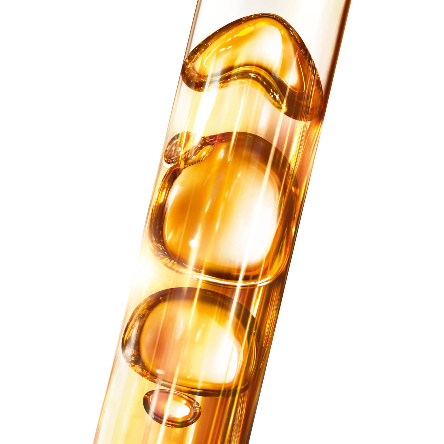 YSL Pure Shots Night Reboot Serum, a close-up of golden liquid with
bubbles in a glass tube, symbolizing potent ingredient extraction.