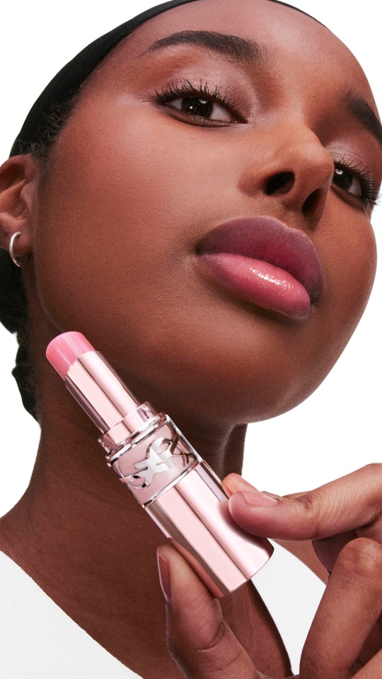 Model wearing YSL LOVESHINE CANDY GLOW lip balm shade with radiant shine.