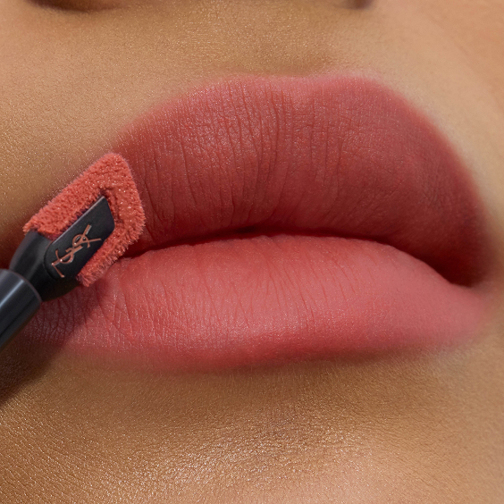 Close-up of soft-matte rosy pink lips being precisely lined with the angled, flat-tipped YSL lip stain applicator.