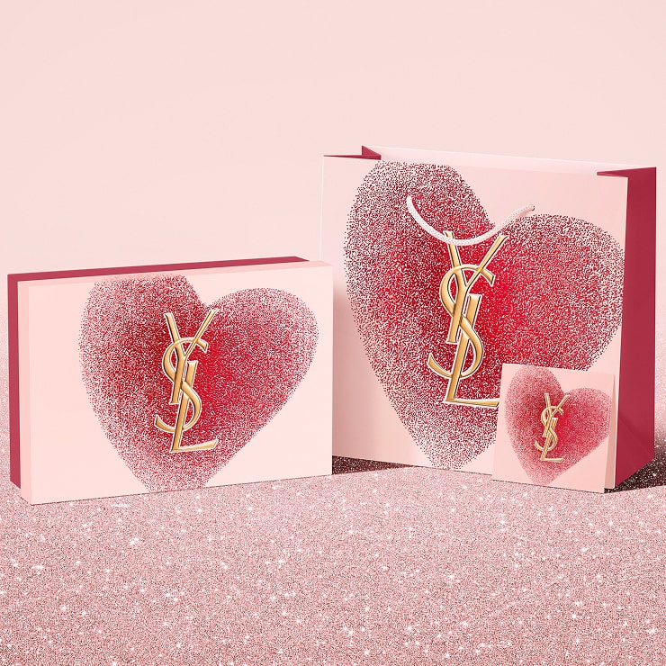 YSL Beauty Valentine's day gift set, gift card, and
shopping bag, featuring a glittery red heart design
with the YSL logo.