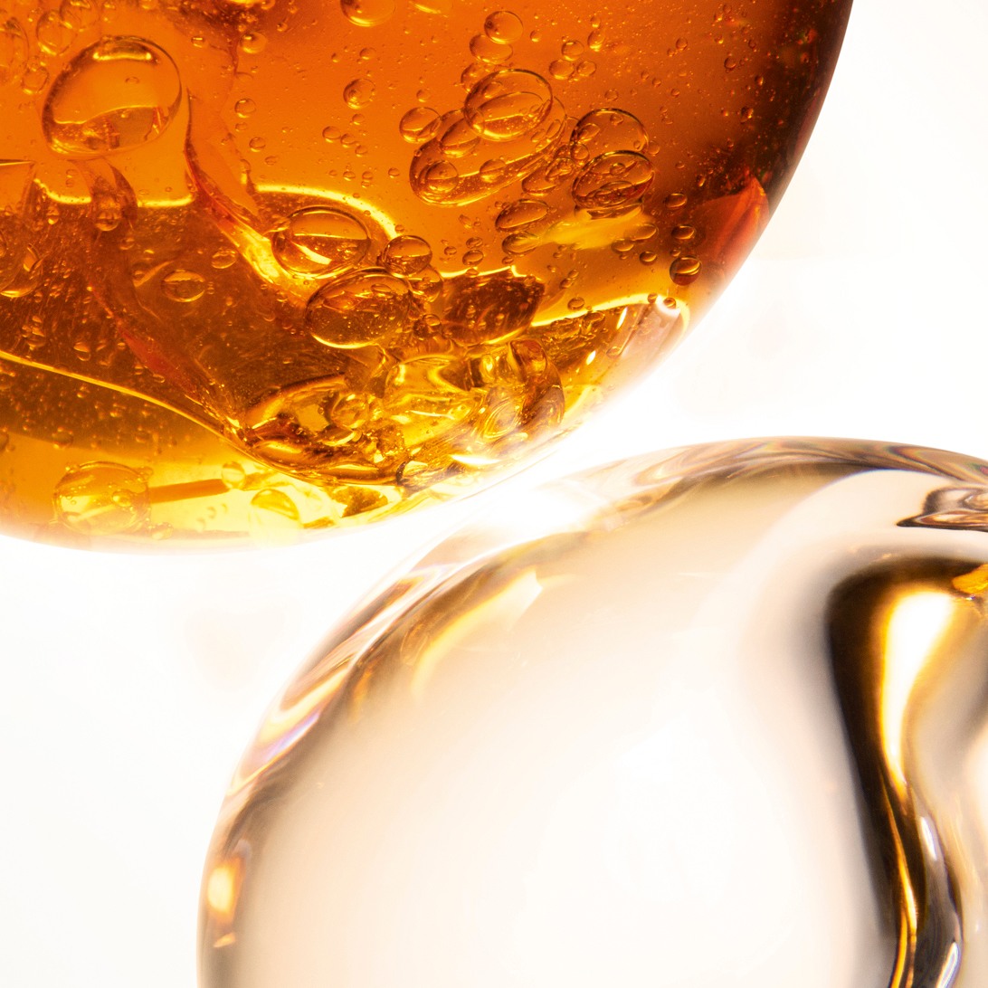 YSL Pure Shots Night Reboot Serum texture, a close-up of golden,
bubbling liquid, highlighting its rich, acidic formula.