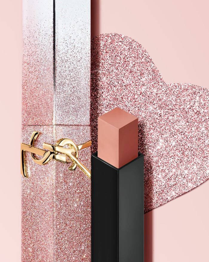 YSL Rouge Pur Couture The Slim Lipstick in a limited edition glitter case, with the bullet exposed, on a pink background.