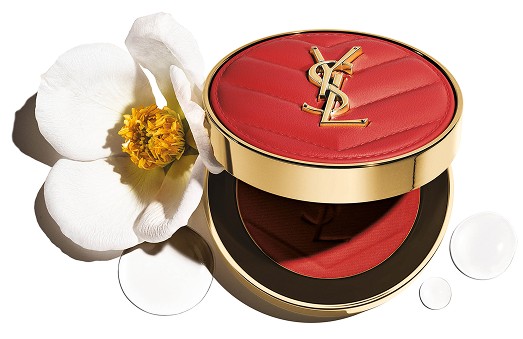 Open YSL Make Me Blush Powder Blush in shade 15, a vibrant red, with a delicate white flower and clear water droplets.