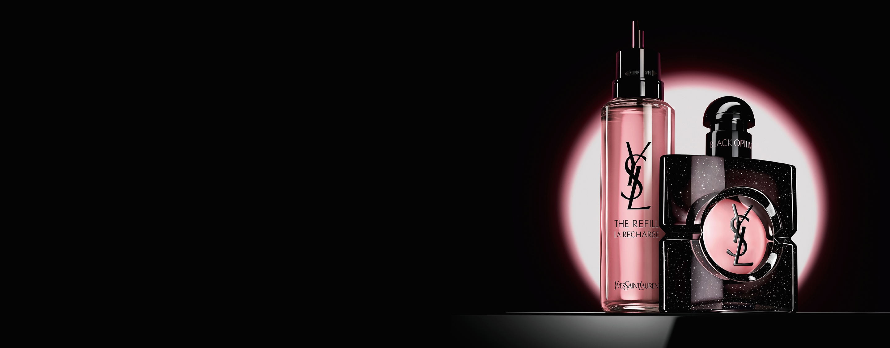 Black Opium Eau de Parfum bottle shown next to its 100ml glass refill bottle with the YSL logo.