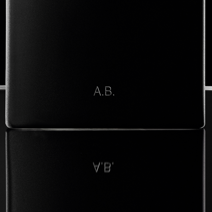 Close-up of the MYSLF Eau de Parfum bottle base featuring personalized A.B. initials engraving.