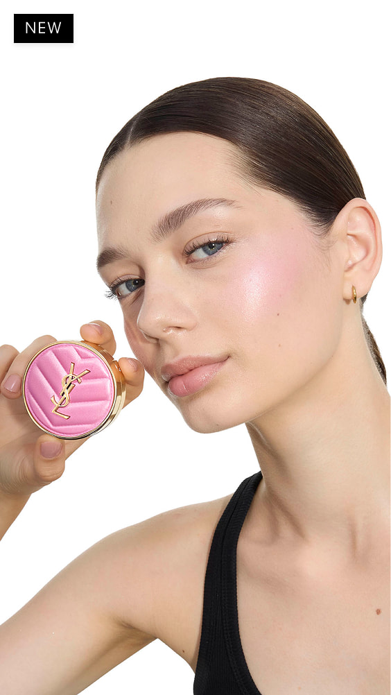 Oksana, fair skin, holding a pink YSL Make Me Blush Powder Blush in
shade 10, showcasing a subtle blush on her cheek.