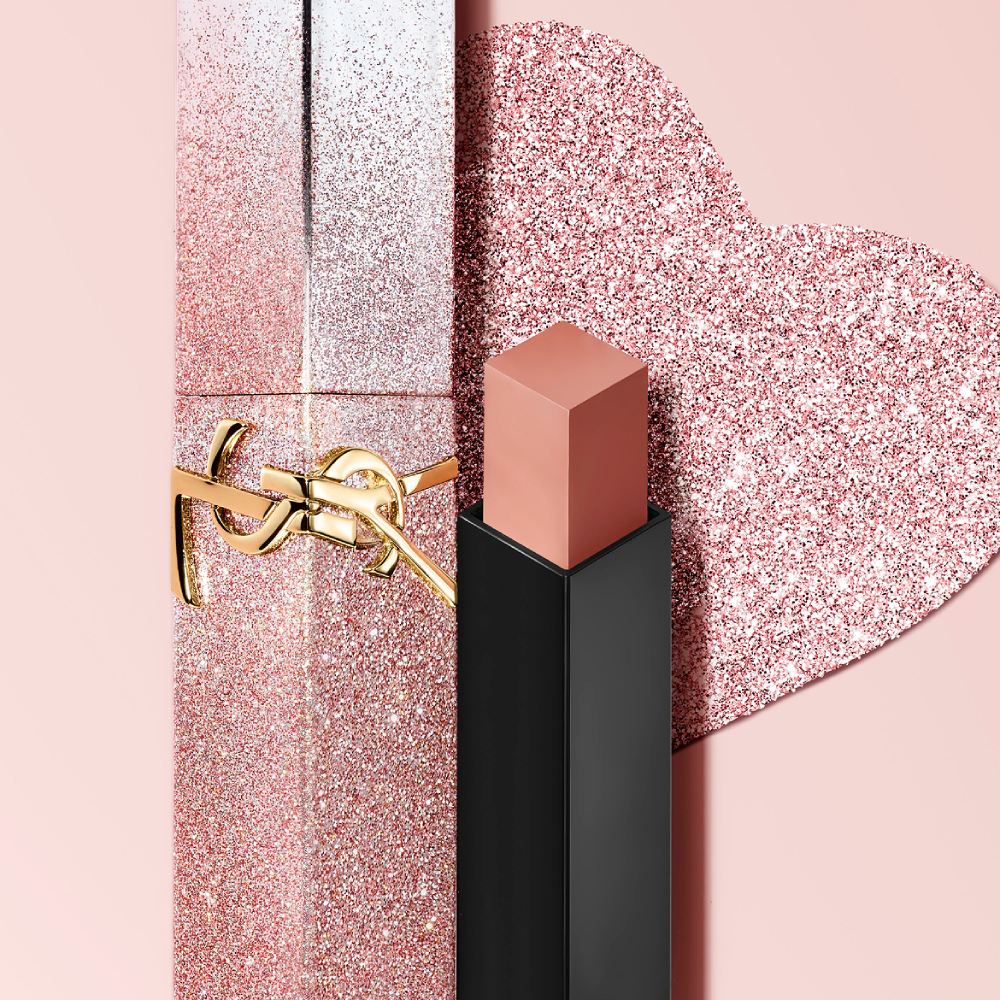 YSL Rouge Pur Couture The Slim Lipstick in a limited
edition glitter case, with the bullet exposed, on a
pink background.