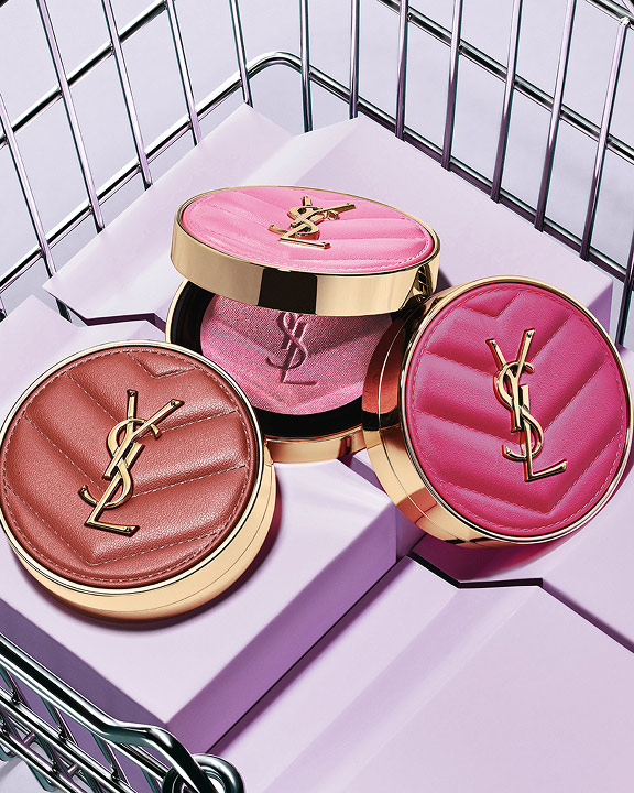 Three YSL Make Me Blush Powder Blush in shades 10, 12, and 66, displayed on purple blocks in a metallic basket.
