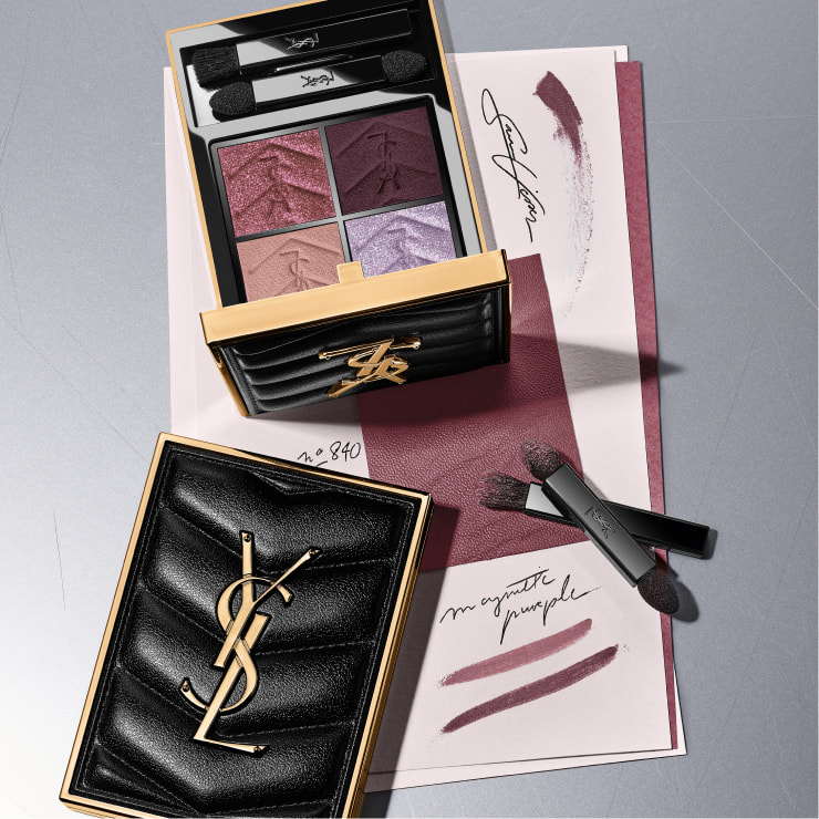 Model showcasing YSL Beauty gift boxes in black with pink and red ribbons, with a black quilted pouch.