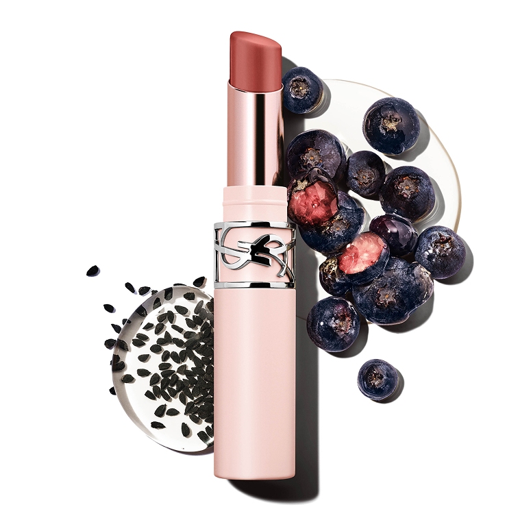 YSL LOVENUDE Lip Blusher in Shade 4, surrounded by blueberries and black cumin seeds, highlighting natural ingredients.