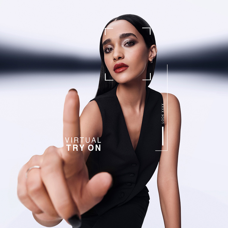 Model with sleek black hair and nails engaging with YSL's Virtual Try-On interface, modern and interactive.