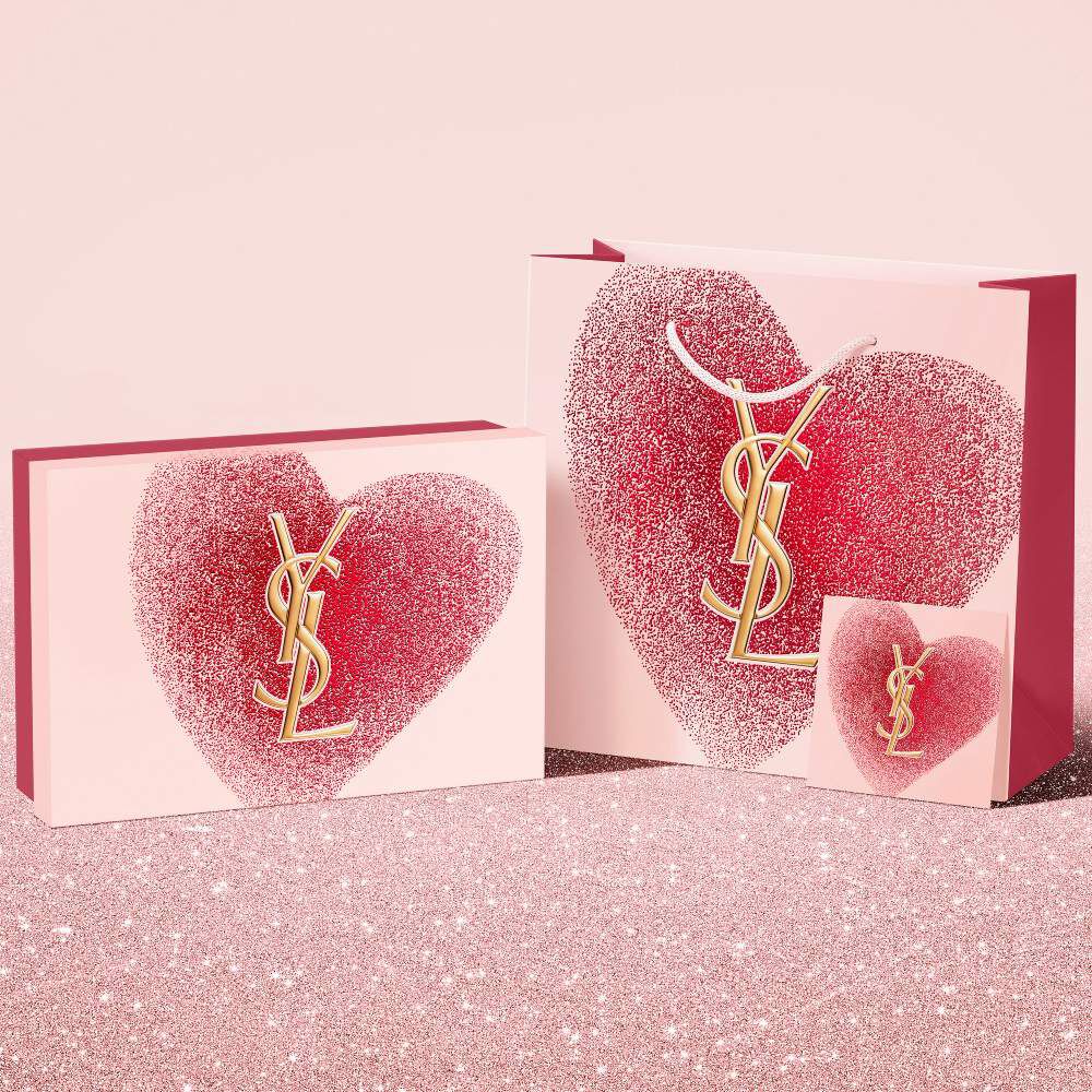 YSL Beauty Valentine's day gift set, gift card, and shopping bag, featuring a glittery red heart design with the YSL logo.