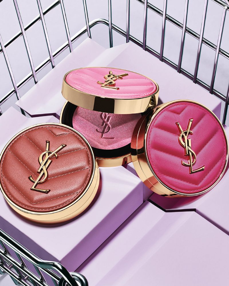 Three YSL Make Me Blush Powder Blush in shades 10, 12, and 66, displayed on purple blocks in a metallic basket.