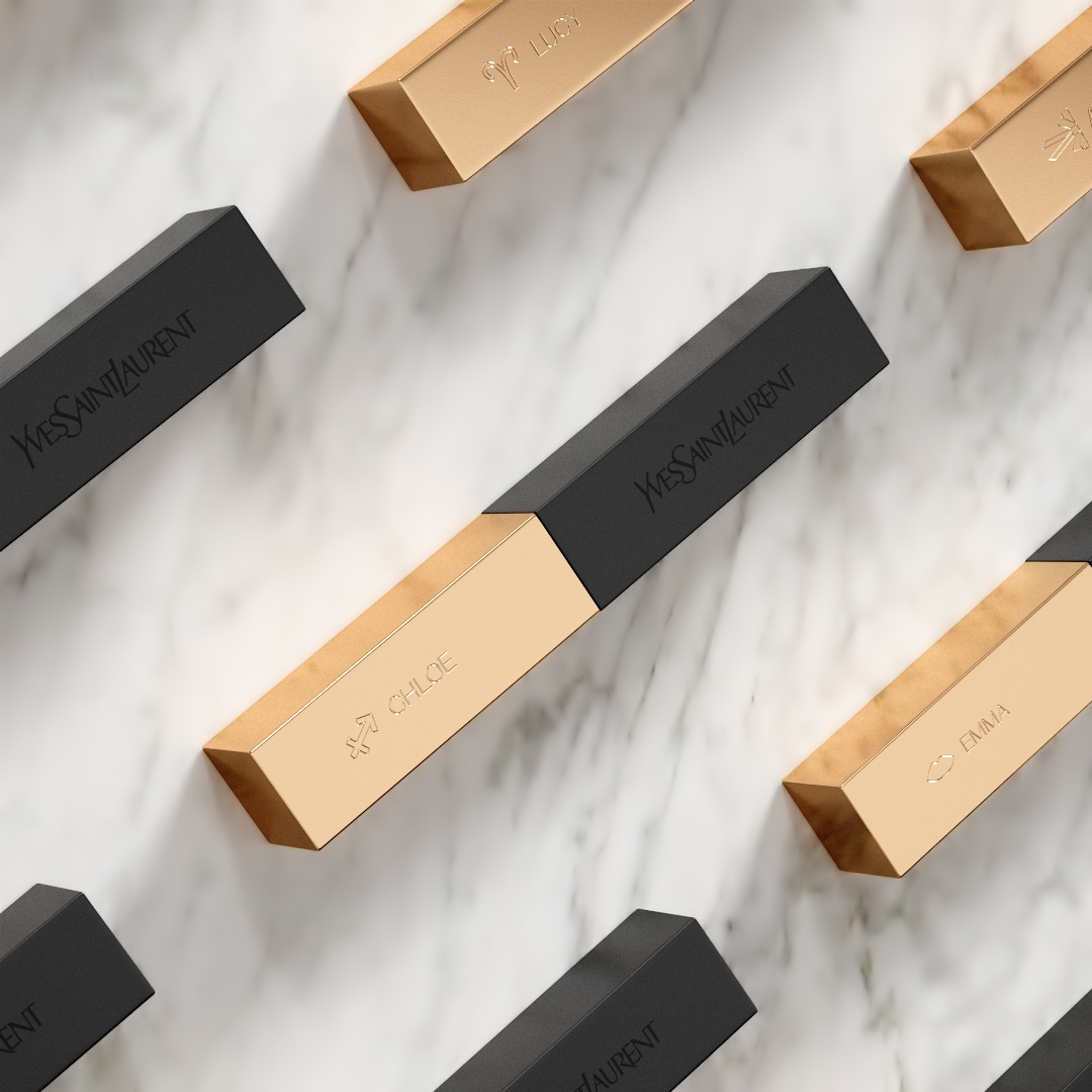 YSL The Slim lipsticks, black and gold, personalized with names like 'Chloe' and 'Lucy', arranged on a white marble surface.