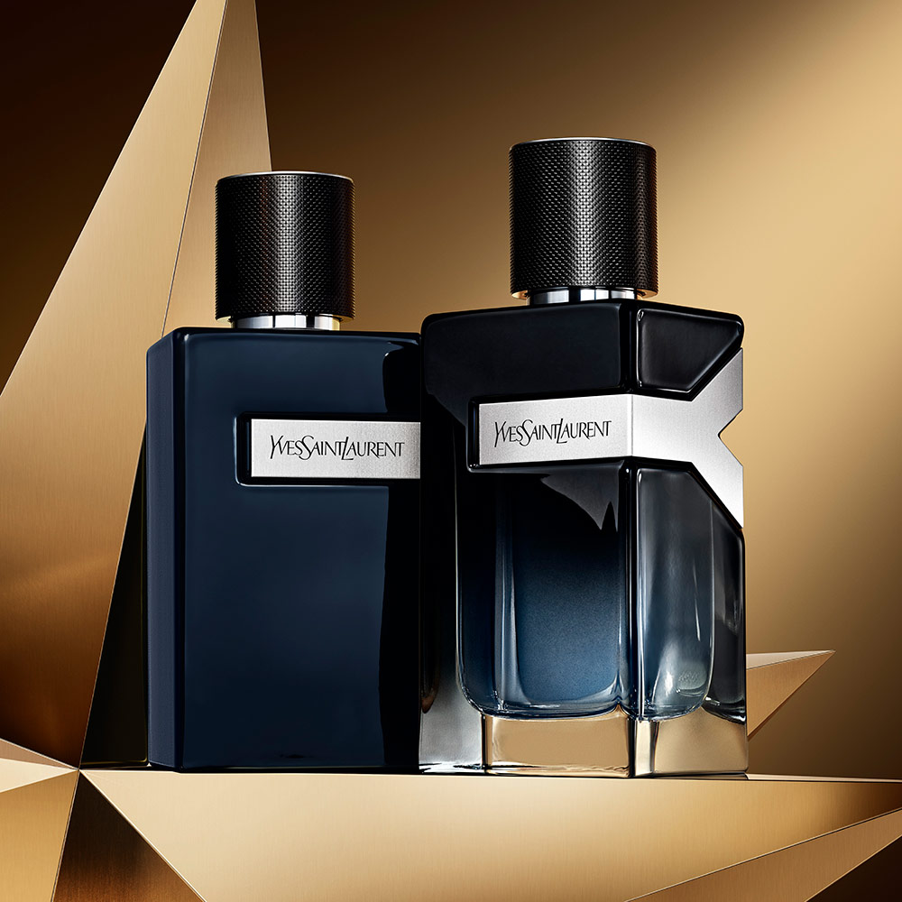 Y eau de parfum bottle and Y le parfum bottle on a golden background.