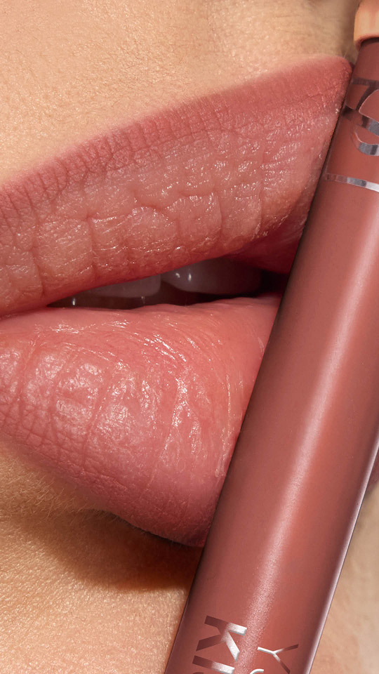 Adrienne's lips with YSL LOVENUDE Kiss Shaper in Shade 103, a close-up showcasing the product.