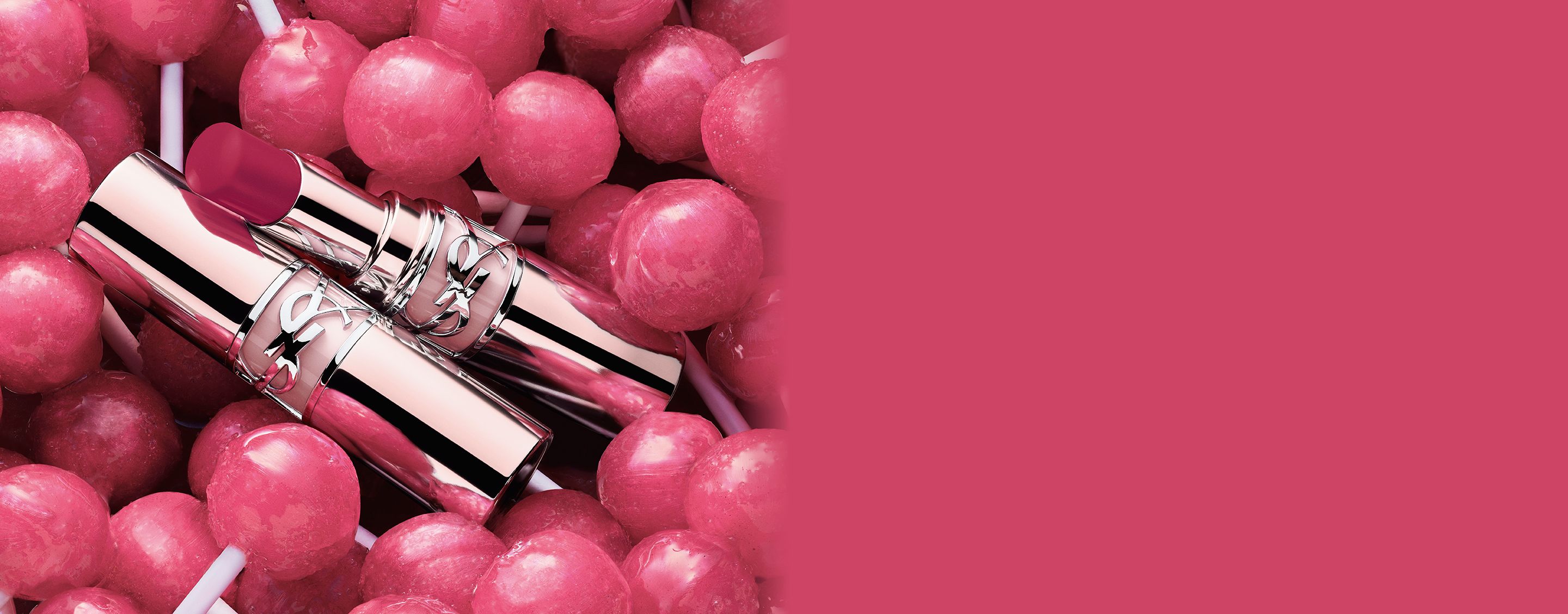 YSL LOVESHINE CANDY GLOW lip balm tubes placed among pink candy lollipops.